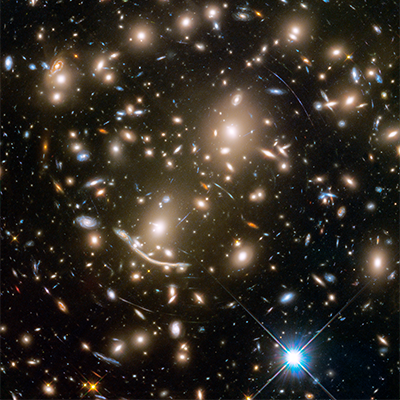 Galaxy cluster Abell 370 photographed by the Hubble Space Telescope. The arcs of light are the effect of gravitational lensing. 